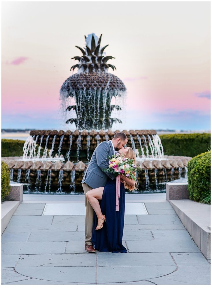 Sunset Engagement Photo of a male and female at the pineapple fountain in Charleston, South Carolina
